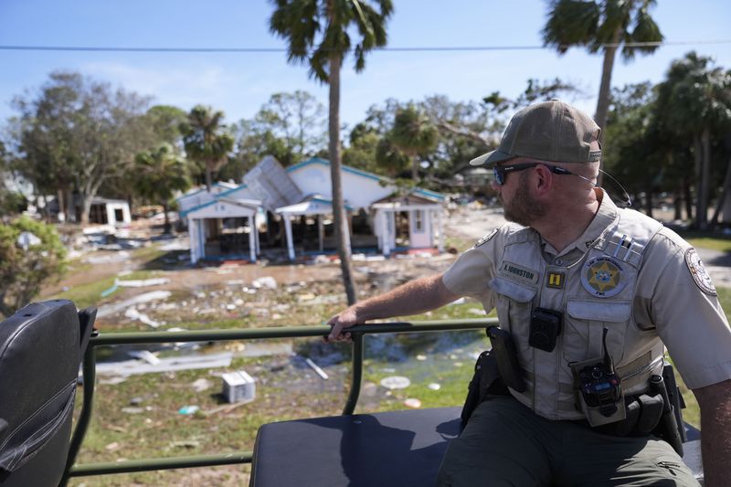 Capt. BJ Johnston, a law enforcement officer from the Florida Wildlife and Fish Conservation Commission, surveys damage from a large water bomb after Hurricane Helene in Cedar Key, Fla., Friday, Sept. 27, 2024. (Gerald Herbert/AP)